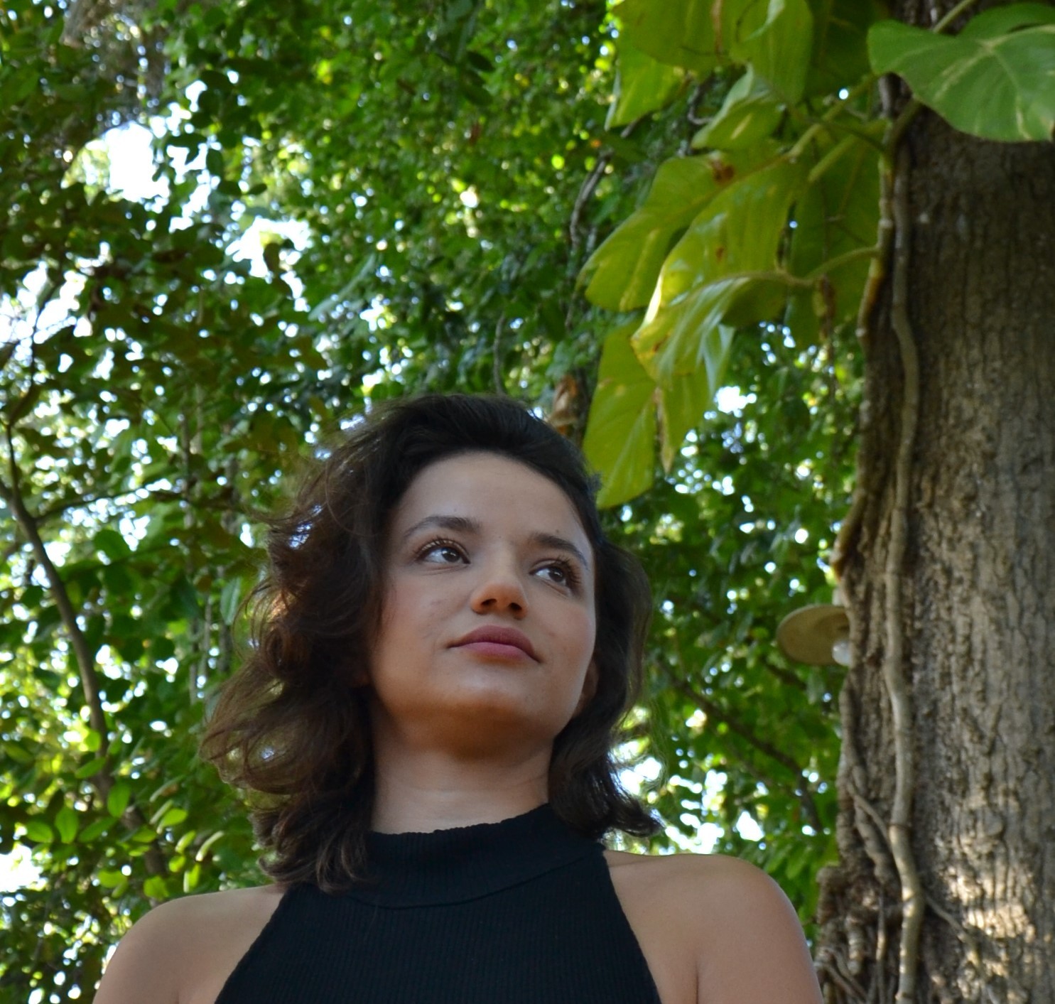 Amanda Zamparo beneath a tree, looking up