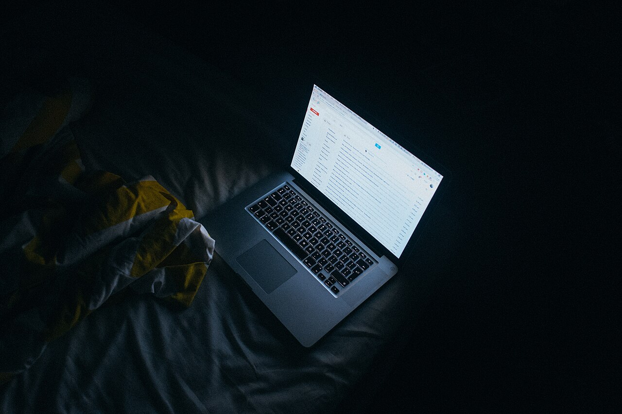 Person reading on a phone in the dark